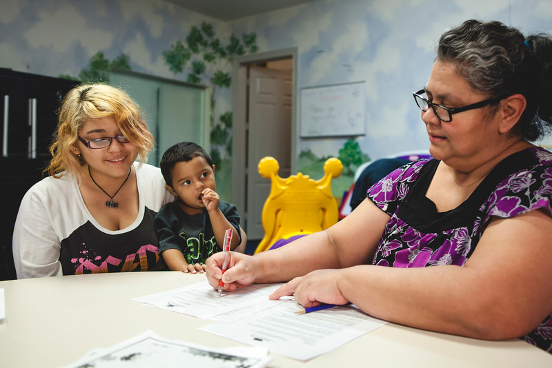 CM - Estella and client with paperwork